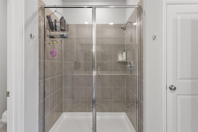 bathroom featuring toilet and walk in shower