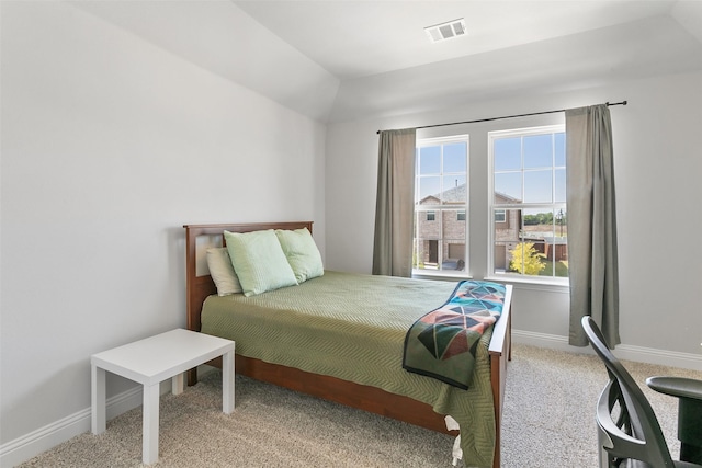 bedroom featuring light carpet and vaulted ceiling