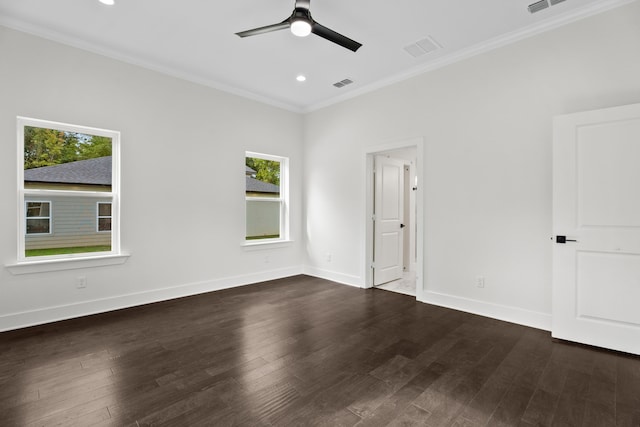 spare room featuring ceiling fan, plenty of natural light, and dark wood-type flooring