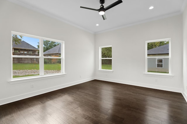 empty room featuring a healthy amount of sunlight, ceiling fan, ornamental molding, and dark hardwood / wood-style floors