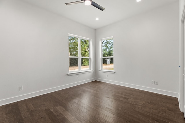 empty room with ceiling fan and dark wood-type flooring