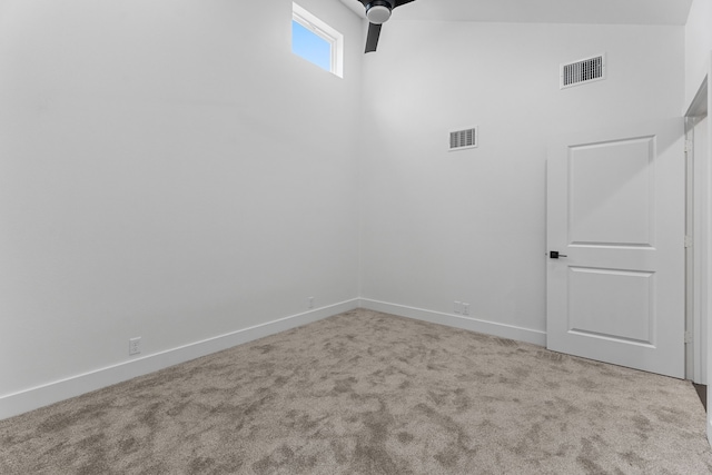 carpeted empty room with lofted ceiling and ceiling fan