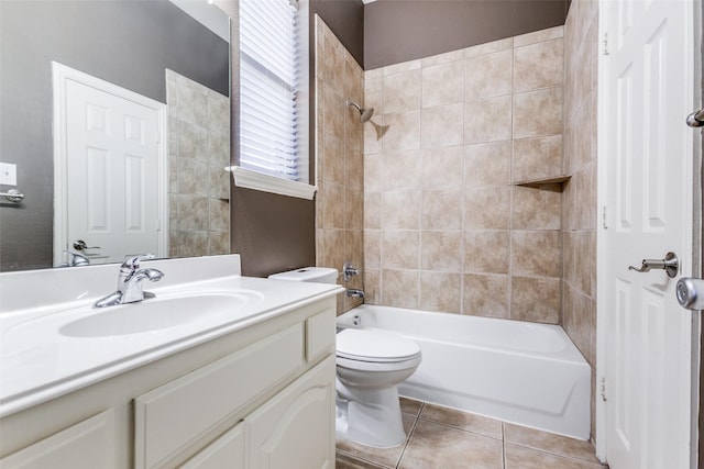 full bathroom featuring toilet, vanity, tile patterned flooring, and tiled shower / bath combo