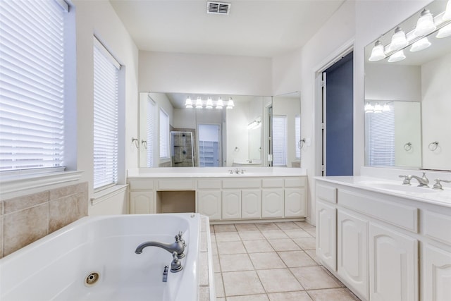 bathroom featuring vanity, tile patterned floors, and separate shower and tub