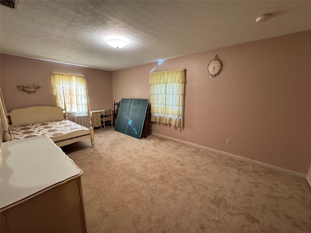 carpeted bedroom with a textured ceiling