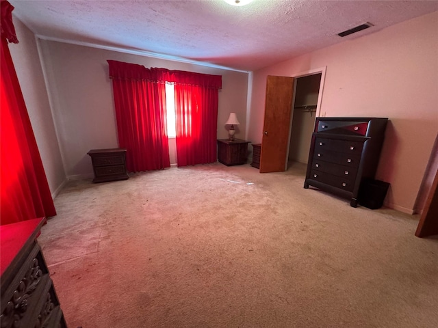 interior space with a textured ceiling and carpet