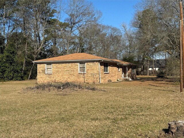 view of home's exterior with a lawn