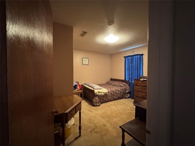 bedroom with a textured ceiling and carpet