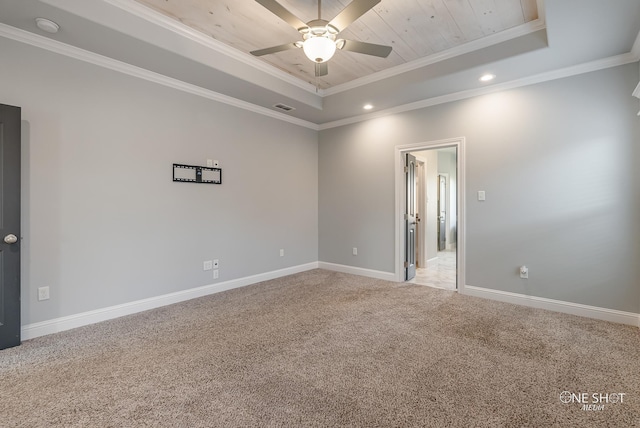 unfurnished room featuring ceiling fan, a tray ceiling, crown molding, and light colored carpet