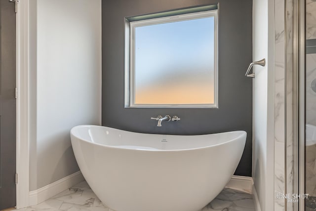 bathroom with a tub to relax in