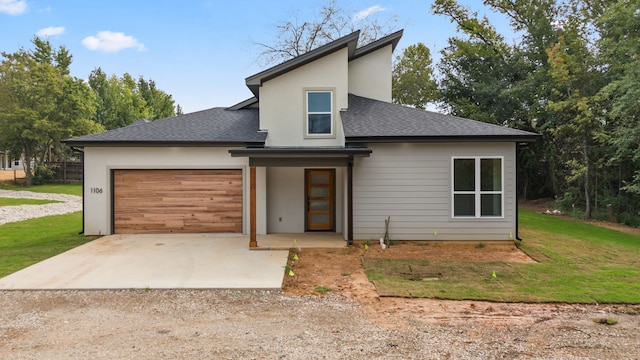 view of front of house with a front yard and a garage