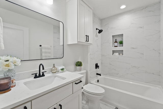 full bathroom with toilet, vanity, and tiled shower / bath