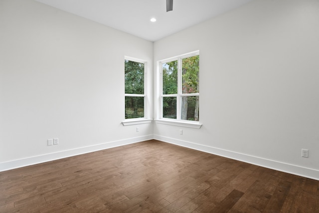 empty room with dark hardwood / wood-style flooring