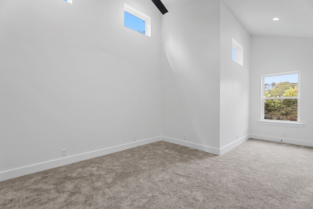 unfurnished room with a high ceiling and carpet