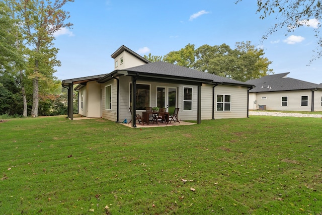 back of house with a patio area, french doors, and a lawn