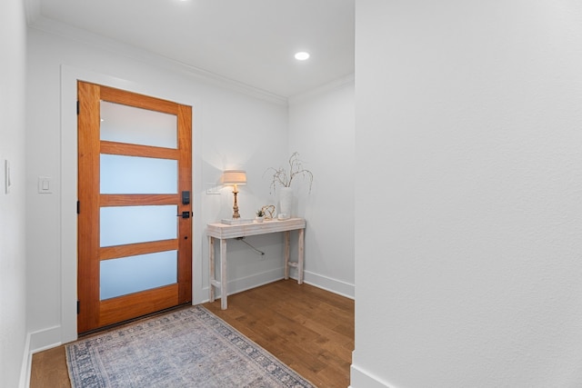 foyer with ornamental molding and hardwood / wood-style flooring