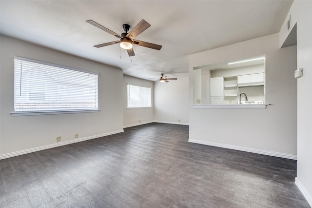 unfurnished living room with ceiling fan and dark hardwood / wood-style flooring