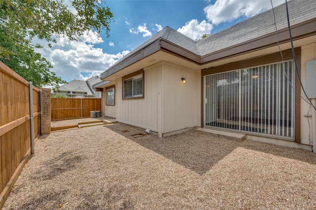 rear view of property with a patio area and cooling unit