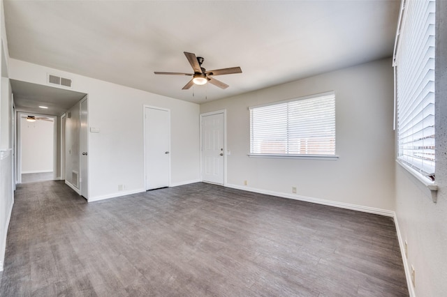 empty room with ceiling fan and dark hardwood / wood-style floors