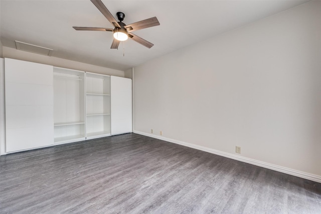 unfurnished bedroom featuring dark wood-type flooring, ceiling fan, and a closet