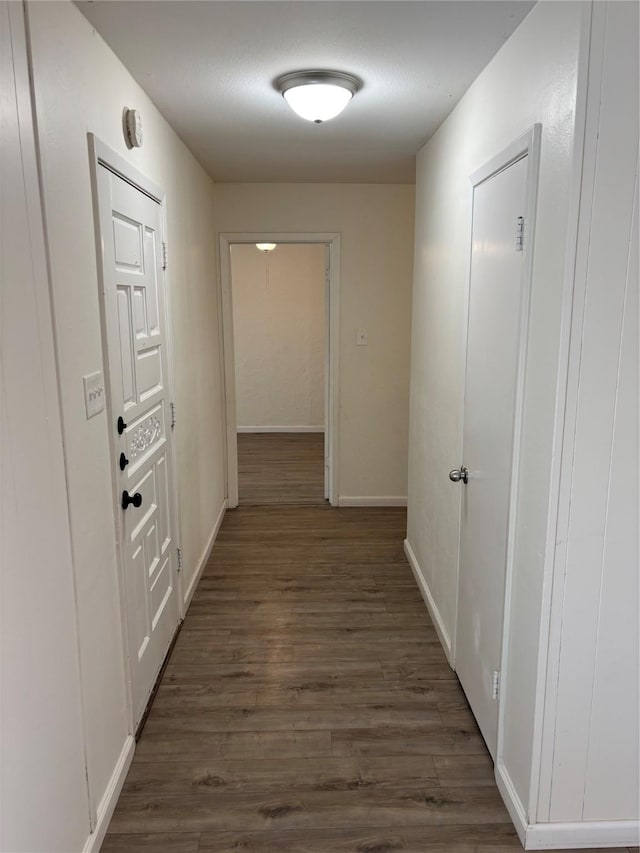 corridor featuring dark hardwood / wood-style flooring