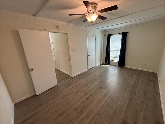 empty room featuring ceiling fan and dark hardwood / wood-style flooring