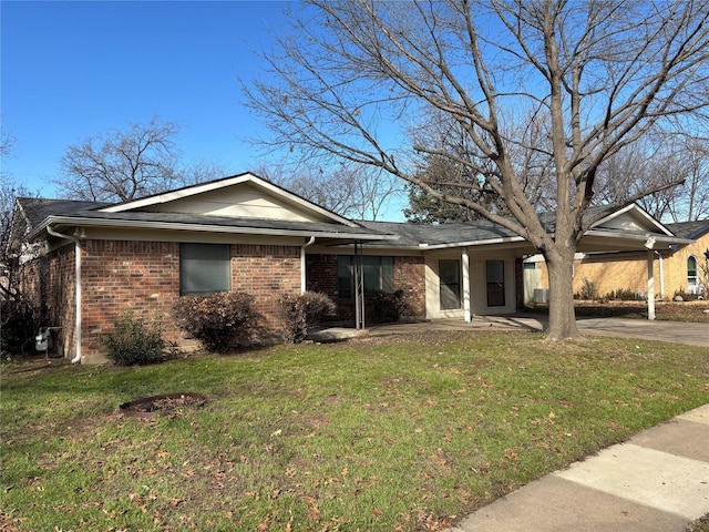 ranch-style house featuring a front yard and a carport