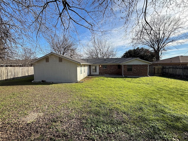 rear view of house featuring a yard