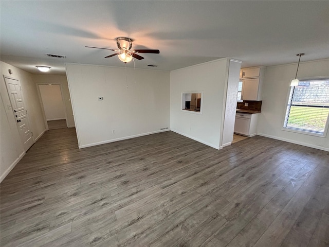 unfurnished living room with ceiling fan and dark hardwood / wood-style floors