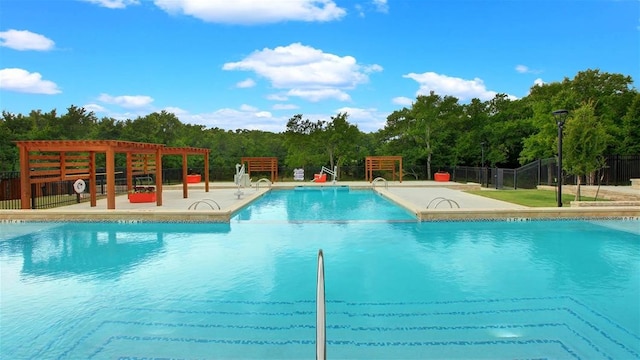 view of swimming pool with a patio area and a pergola