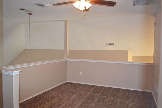 spare room with lofted ceiling, carpet floors, and ceiling fan