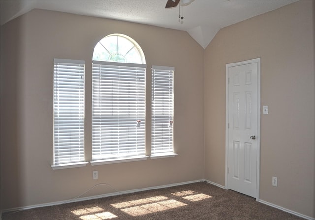 carpeted spare room with lofted ceiling and ceiling fan