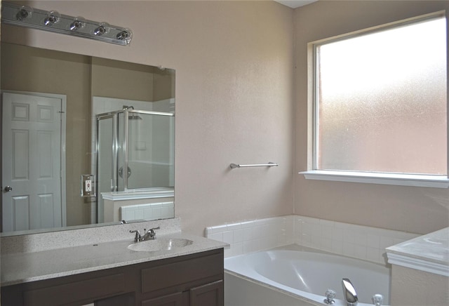 bathroom with shower with separate bathtub and vanity