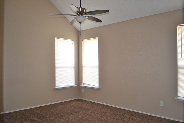 empty room featuring lofted ceiling, carpet flooring, ceiling fan, and a wealth of natural light