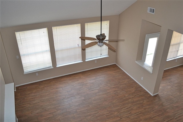 unfurnished living room featuring ceiling fan, dark hardwood / wood-style flooring, and vaulted ceiling