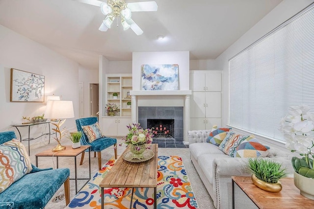 living room featuring a fireplace and ceiling fan