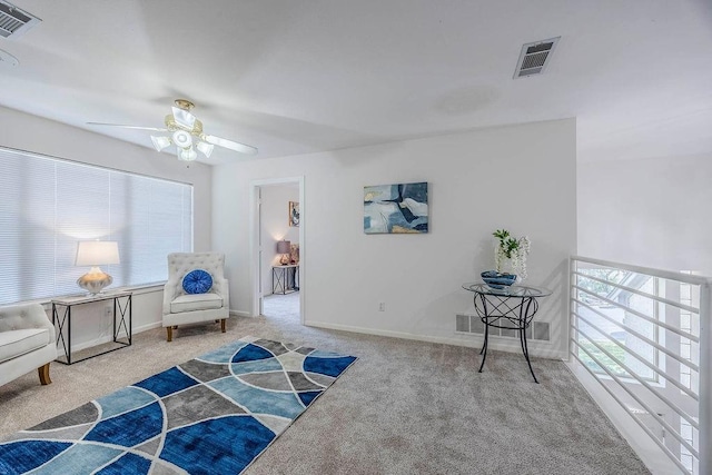 sitting room featuring light carpet, ceiling fan, and plenty of natural light