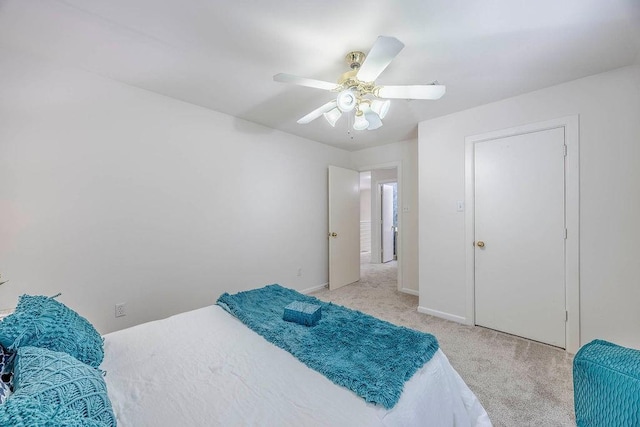 bedroom with ceiling fan and light carpet