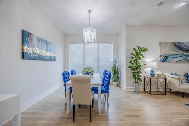 dining room featuring light hardwood / wood-style flooring and a chandelier