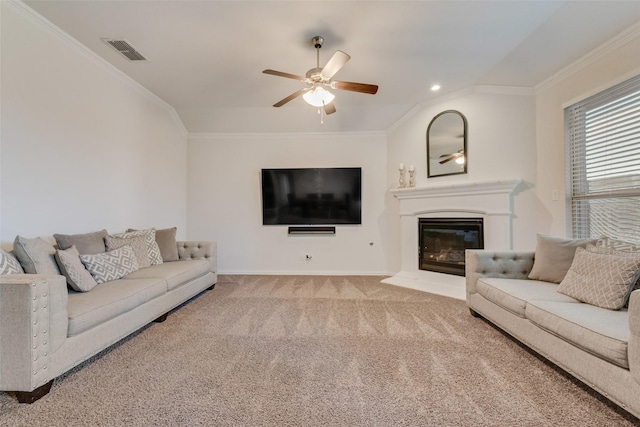 carpeted living room with ceiling fan and crown molding