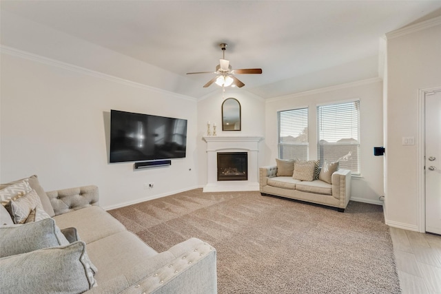 living room featuring carpet, ornamental molding, and ceiling fan