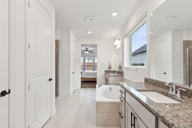 bathroom featuring ceiling fan, a shower with door, tile patterned floors, and vanity