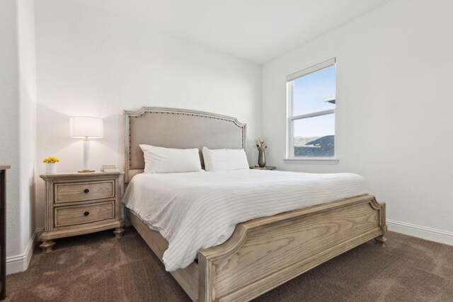 bedroom featuring dark colored carpet