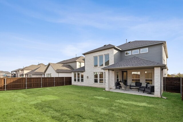 rear view of house with a patio area, an outdoor hangout area, and a yard