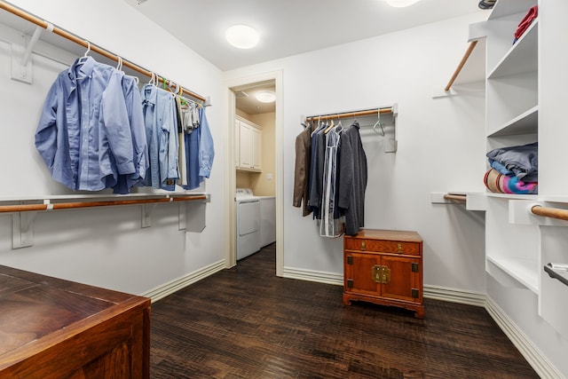 spacious closet with separate washer and dryer and dark hardwood / wood-style floors