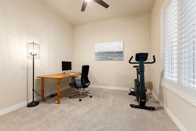 office area with light colored carpet, ceiling fan, and a healthy amount of sunlight