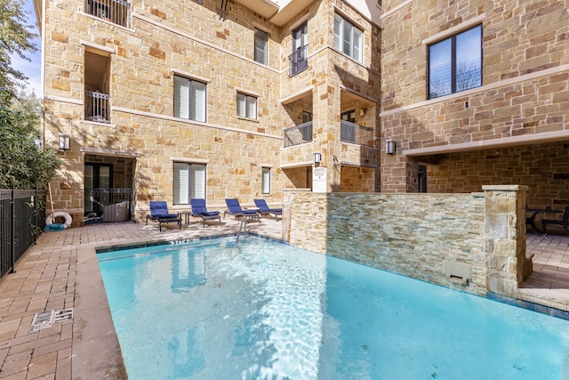 view of swimming pool with pool water feature