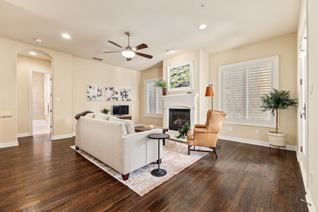 living room with ceiling fan, a healthy amount of sunlight, and dark hardwood / wood-style floors