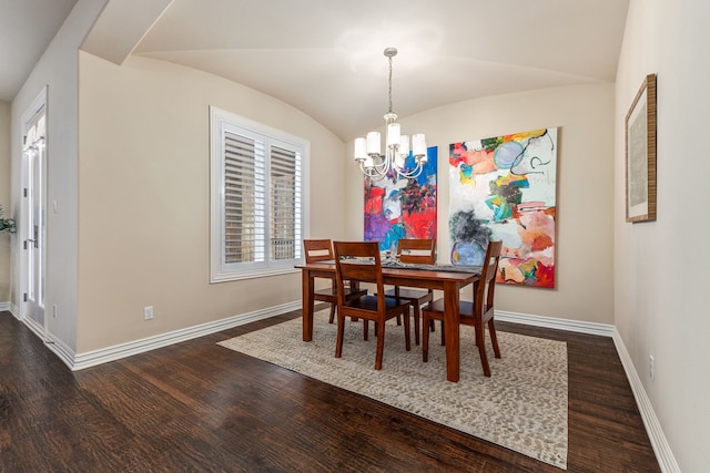 dining room with a notable chandelier, dark wood-type flooring, and vaulted ceiling