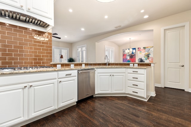 kitchen with kitchen peninsula, white cabinets, decorative light fixtures, and decorative backsplash